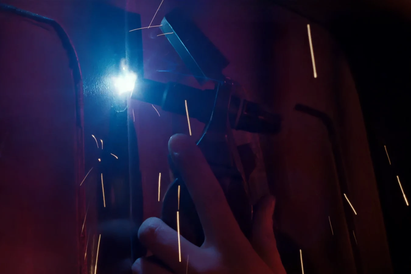 ME3 Hand Welder cutting torch sparking against a metal door seam