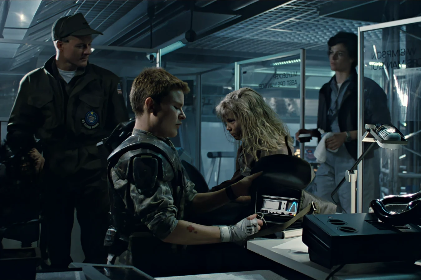USCM corpsman medic pouch open on the ops table with portable vitals monitor during Newt's exam in Aliens