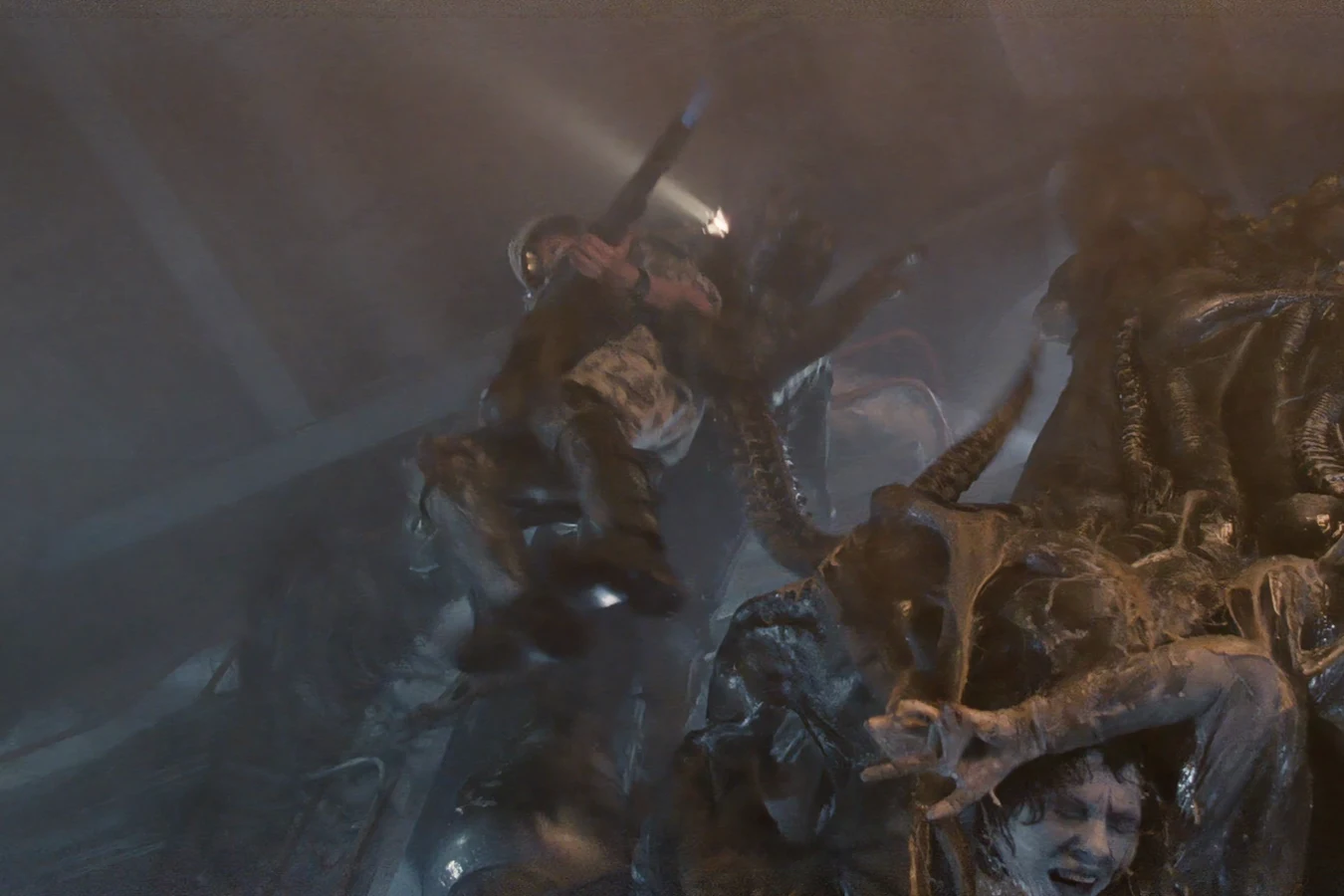 A Warrior dragging Dietrich up into the Hadley's Hope hive as she fires an M240 flamethrower in Aliens