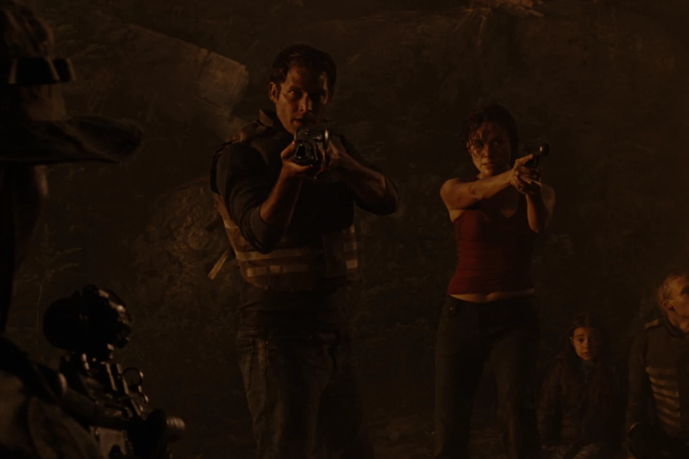 Dallas Howard and Kelly O'Brien aim their weapons at the helicopter crash site