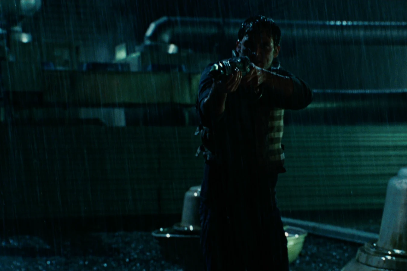 Dallas Howard aims Wolf's plasma pistol on the rain-soaked hospital roof