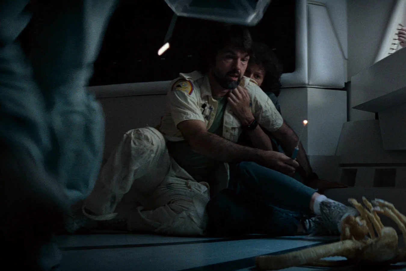 Dallas examines the dead Facehugger in the Nostromo infirmary in Alien