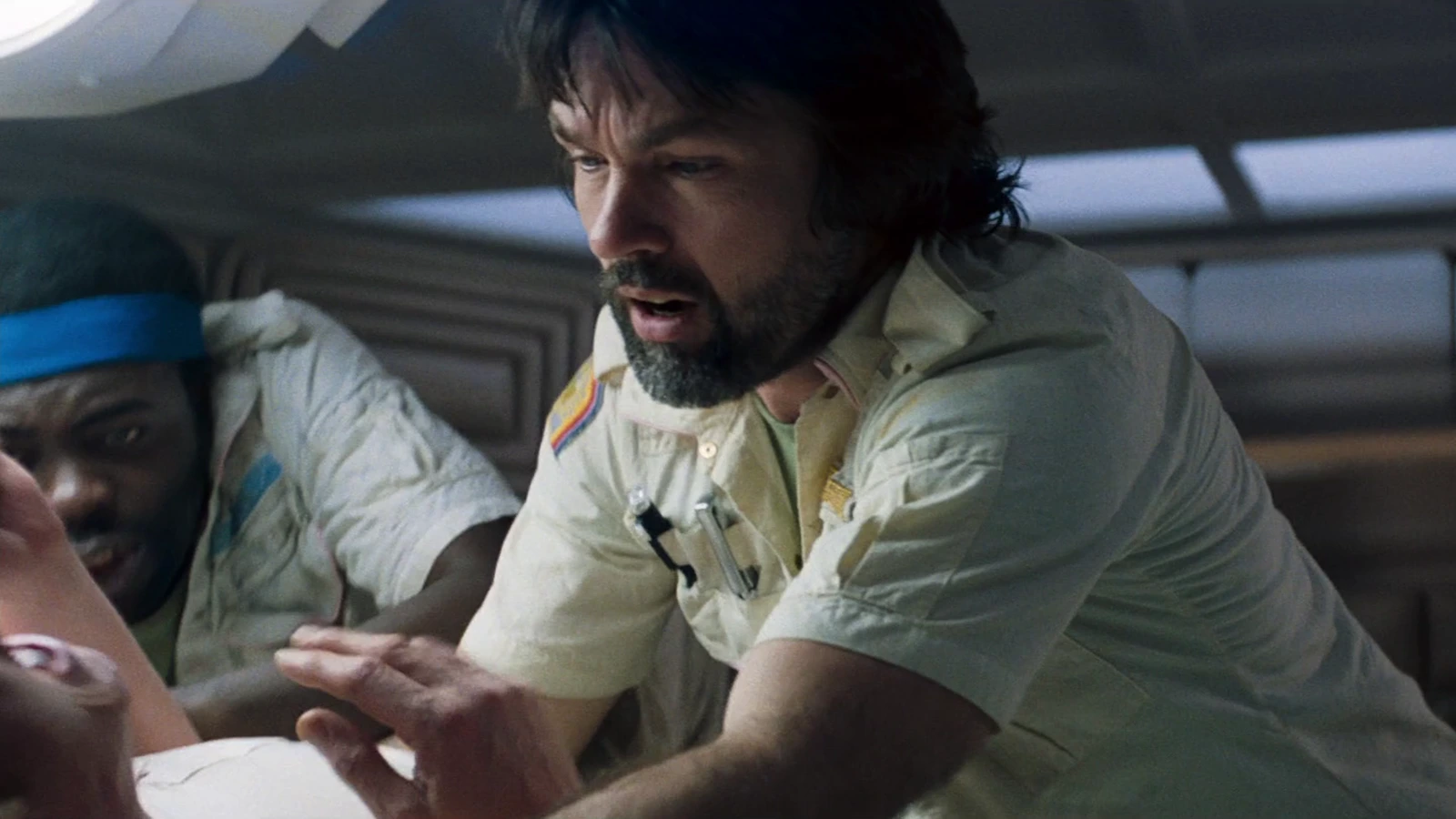 Captain Dallas leaning over Kane during the chestburst in Alien