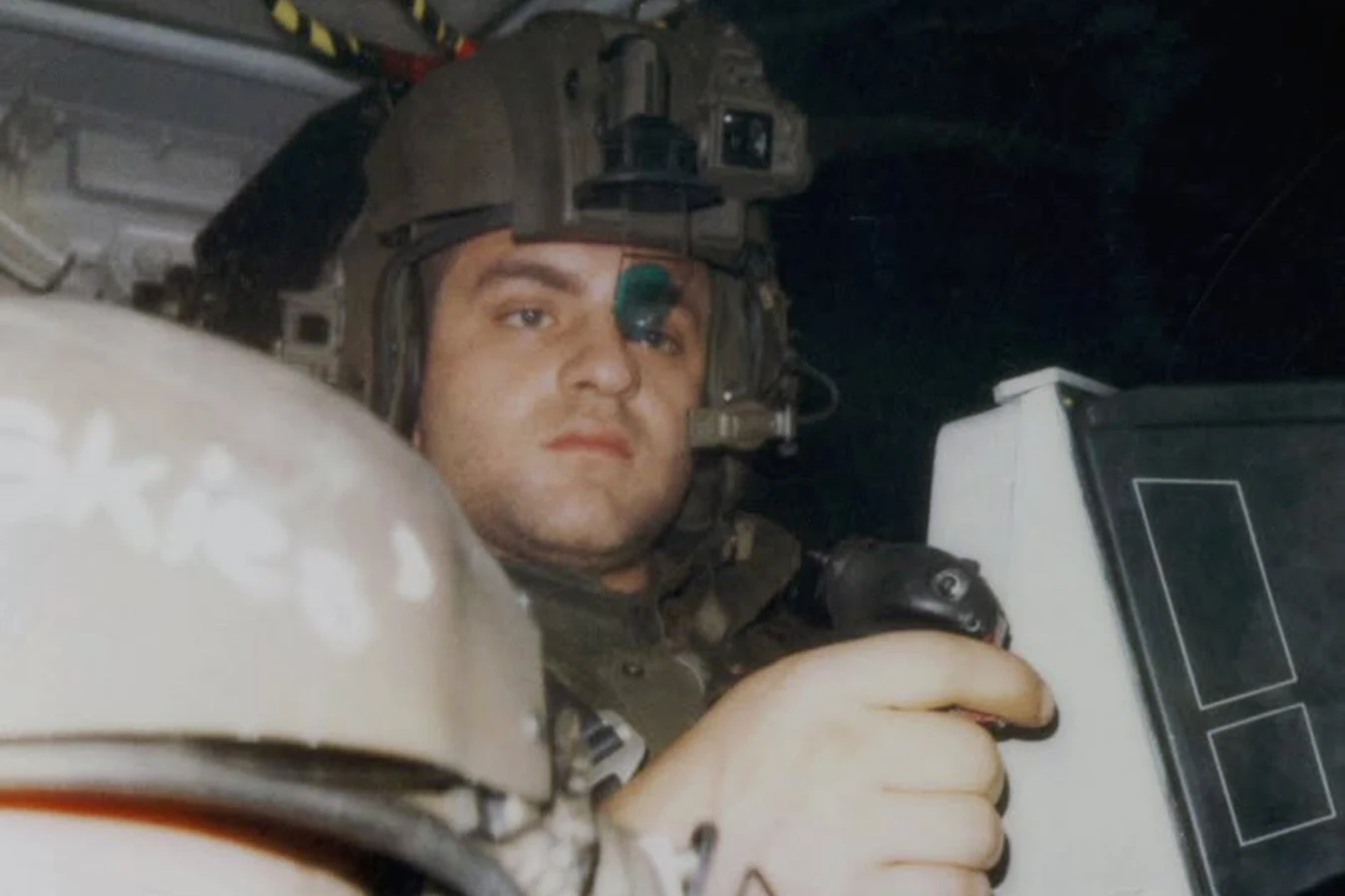 Daniel Kash as Spunkmeyer in a flight helmet and green eyepiece at the Bug Stomper controls during filming of Aliens