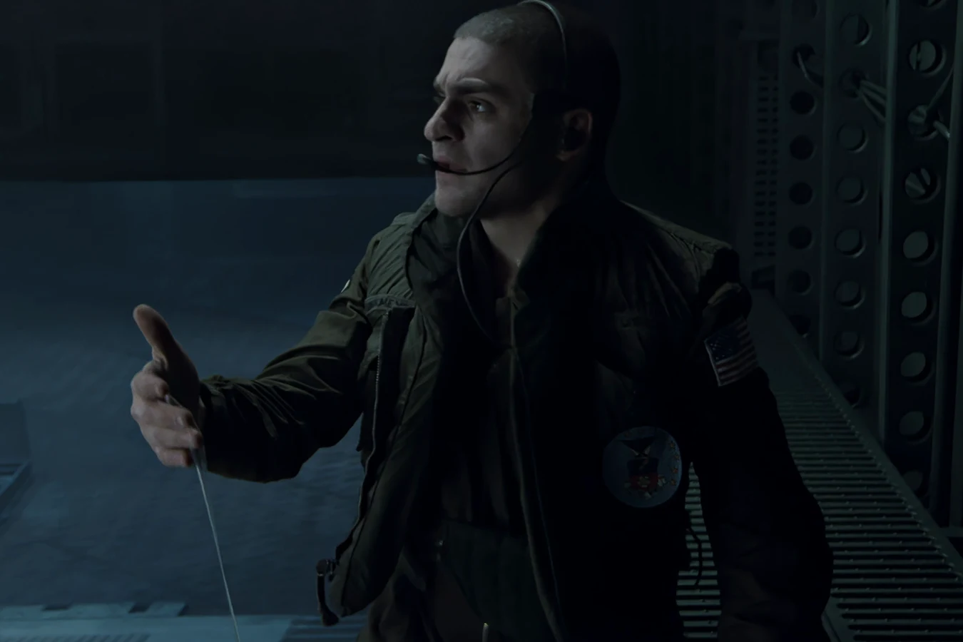Daniel Spunkmeyer in a flight jacket and headset on the Bug Stomper ramp after finding Xenomorph slime in Aliens
