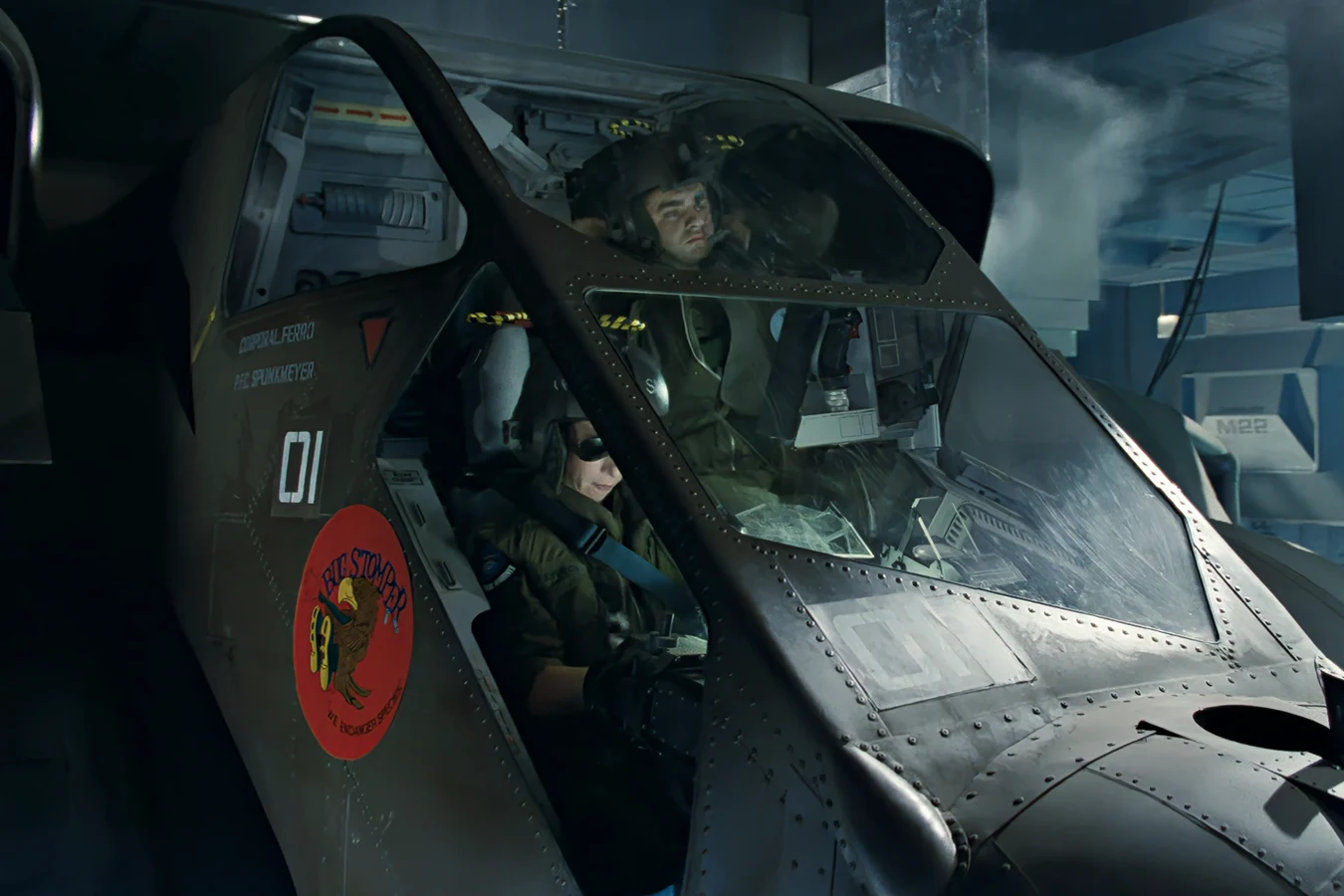 Spunkmeyer in the rear Bug Stomper seat behind Ferro, with Bug Stomper nose art and a white 01 on the hull in Aliens
