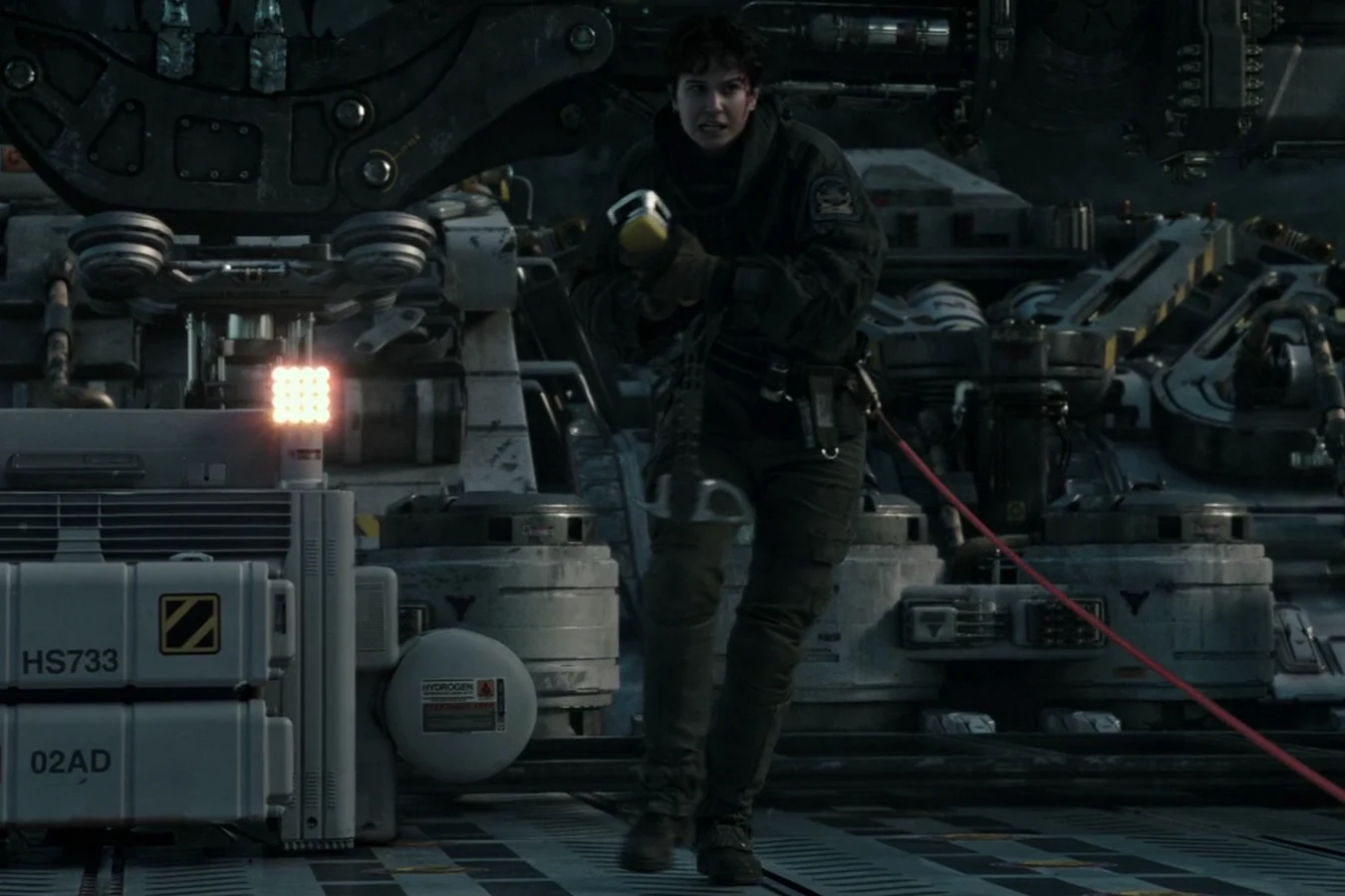 Daniels on the cargo-lift deck with a yellow-handled tool as a Protomorph clings to the hull
