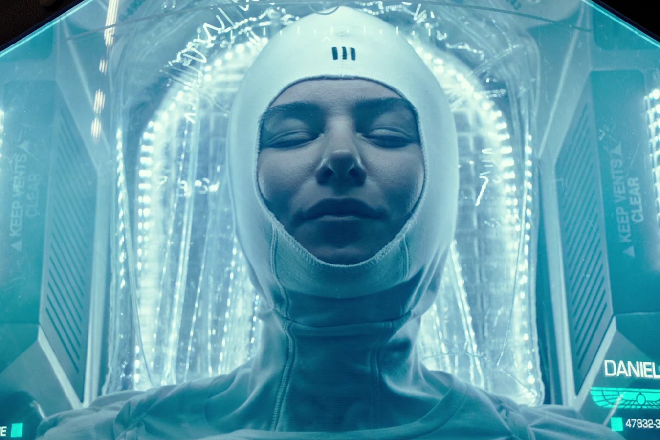 Daniels asleep in her hypersleep pod, labeled on the chamber glass