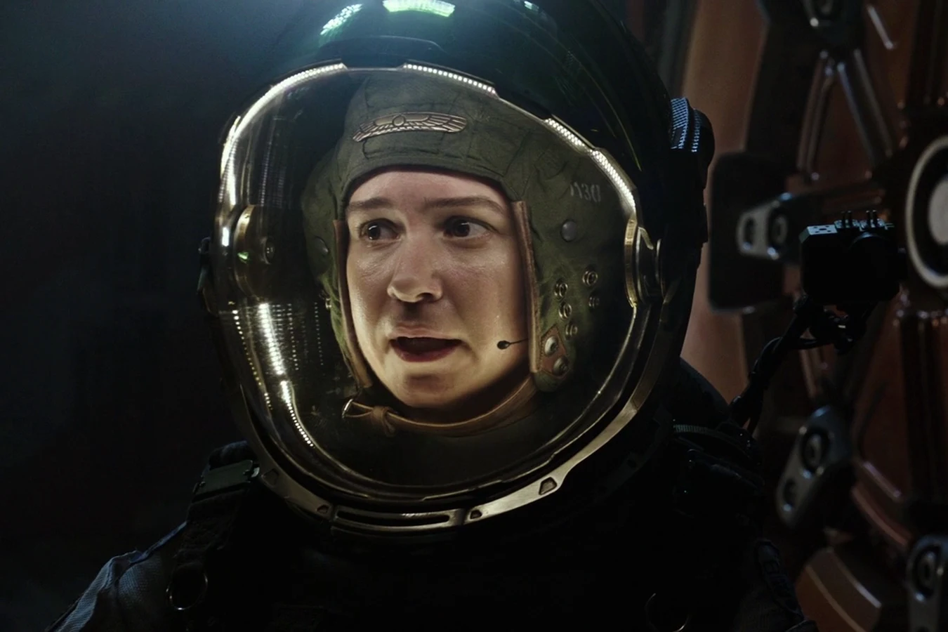 Daniels in an EVA helmet at a hatch after the cargo-lift fight with the Protomorph