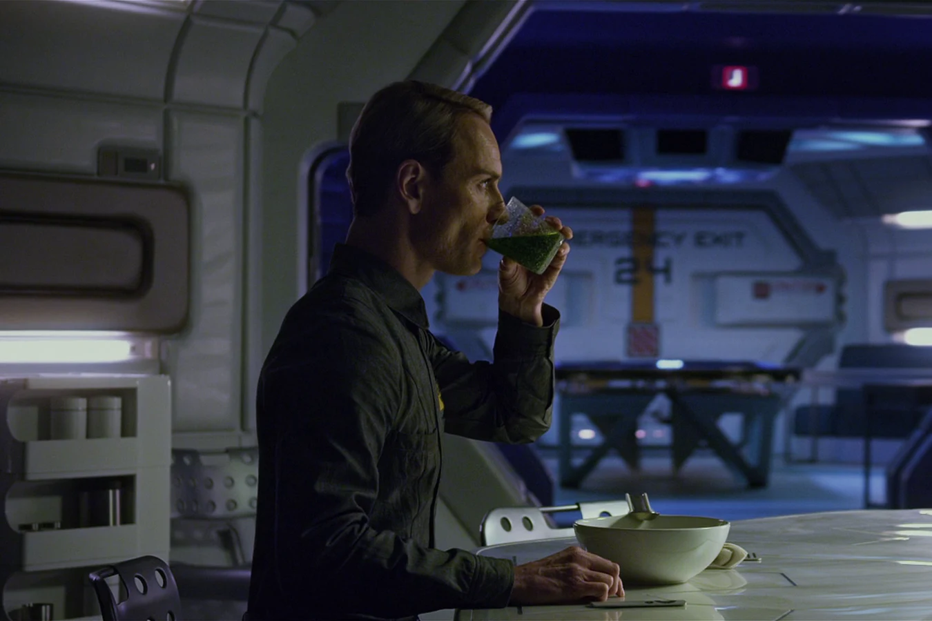 David drinking at the galley counter of the Prometheus while the crew slept