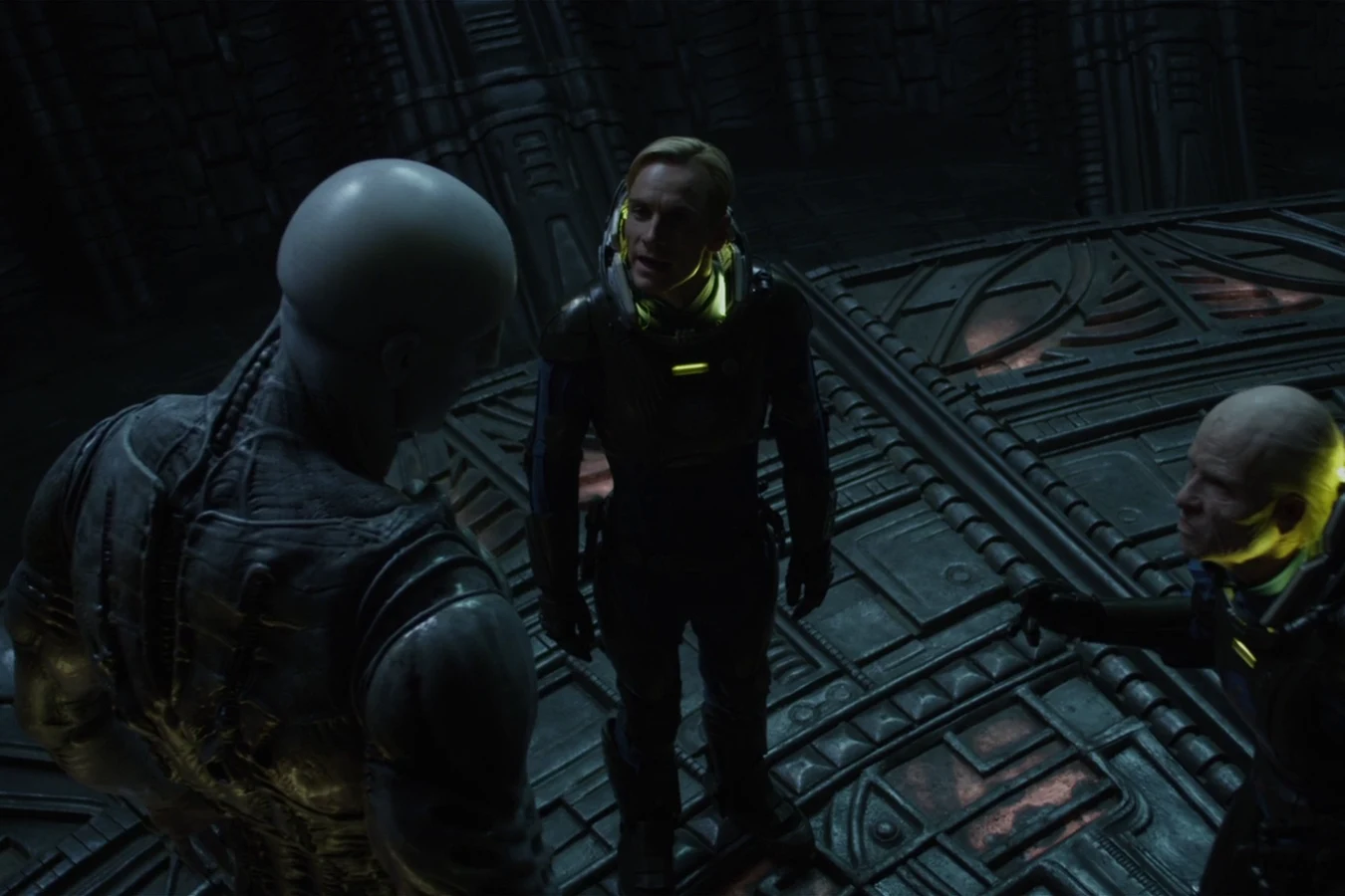 David facing the towering Engineer with Peter Weyland and the security team in the background