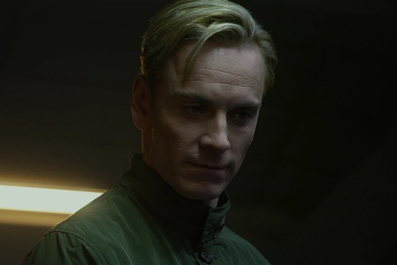 Close view of David in a green jacket aboard the Prometheus