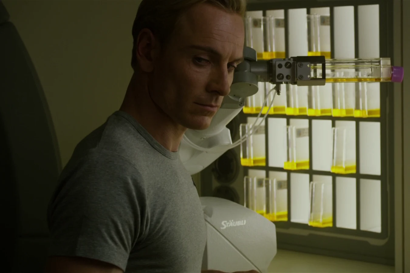 David in a grey shirt handling sample containers in the lab of the Prometheus