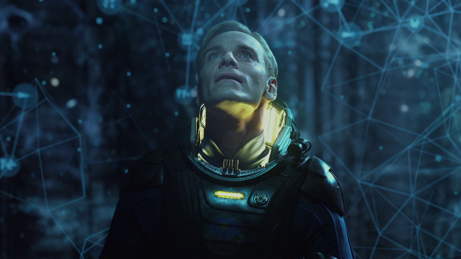 David in his Prometheus spacesuit standing inside the glowing Engineer star map
