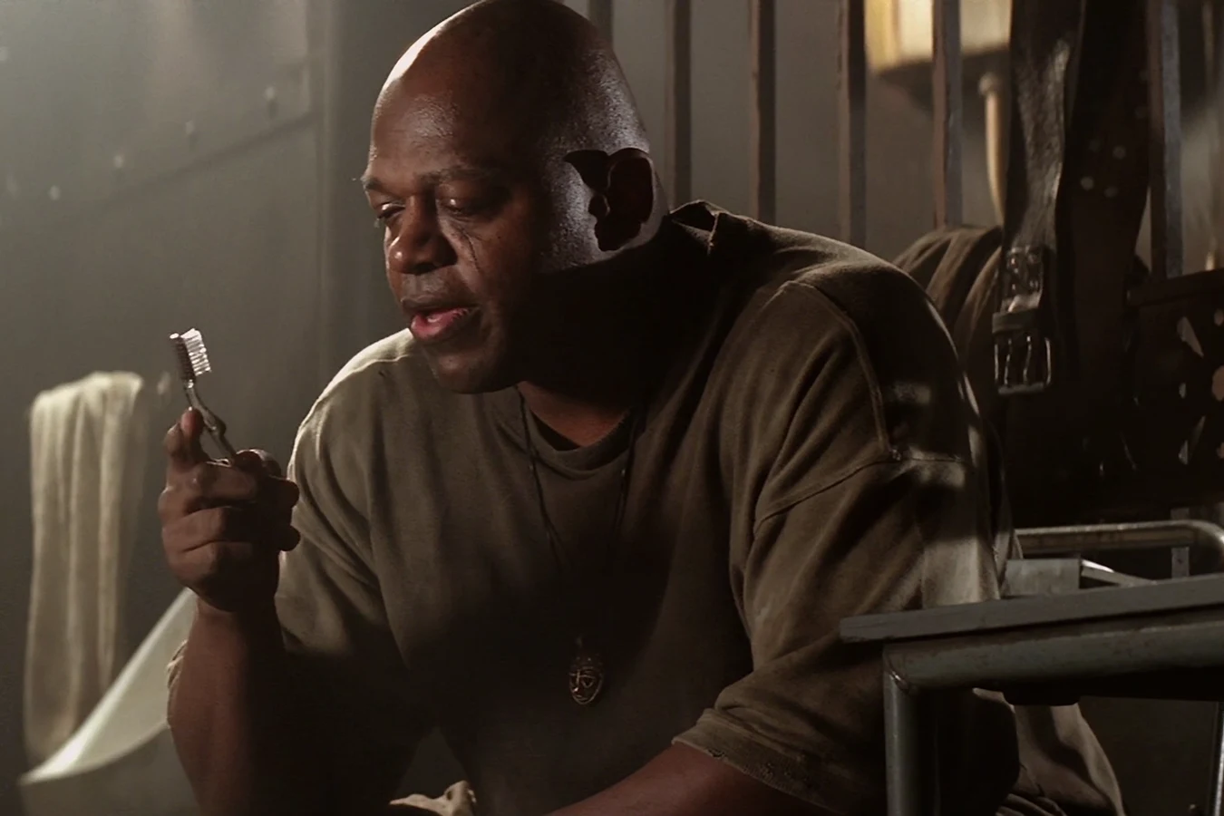 Dillon in his cell holding a toothbrush in Alien 3