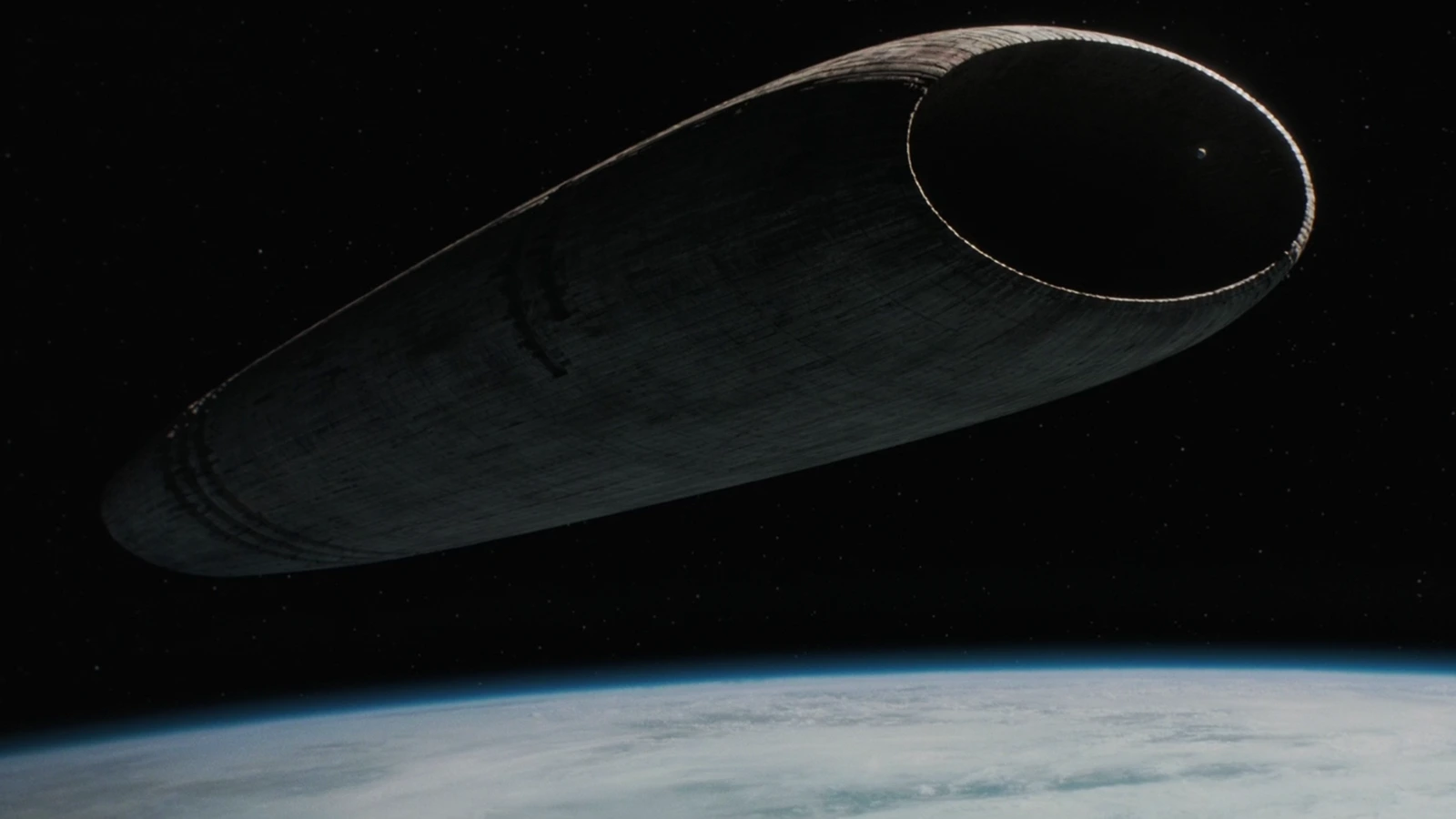 A Guild Heighliner floating above a planet in deep space