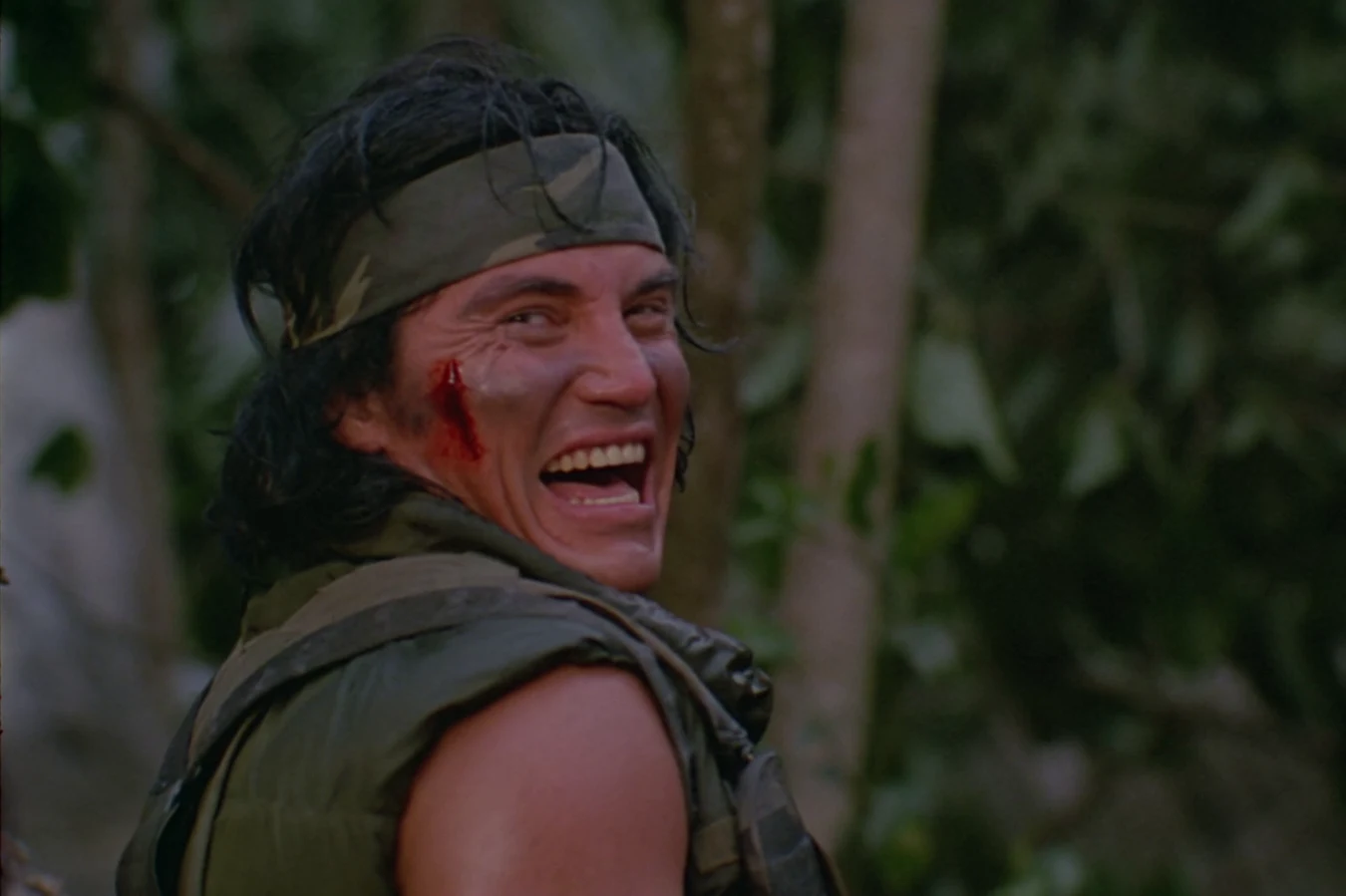 Billy Sole laughing with a cut on his cheek in Predator