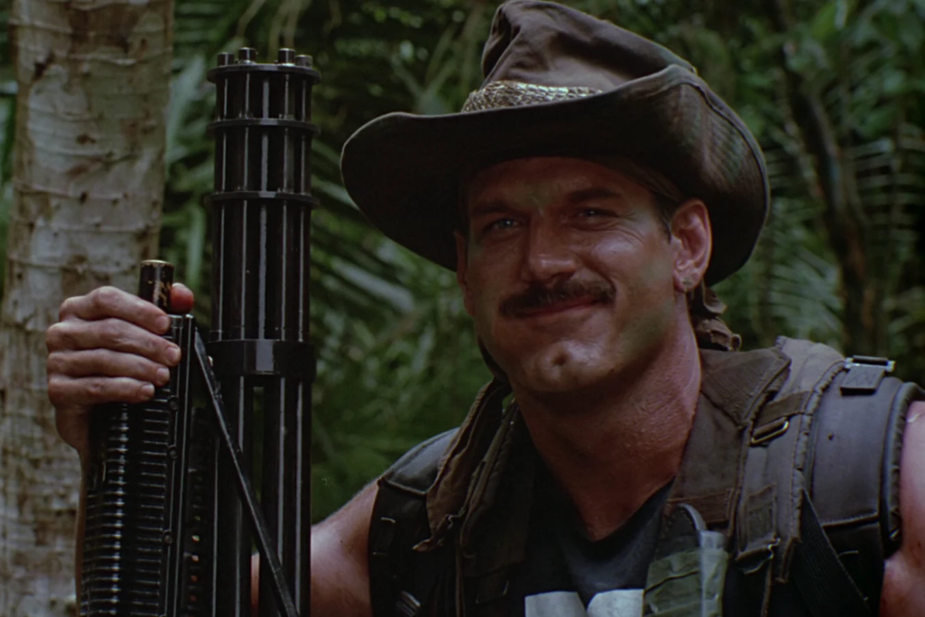 Blain Cooper holding the Ol' Painless minigun in Predator