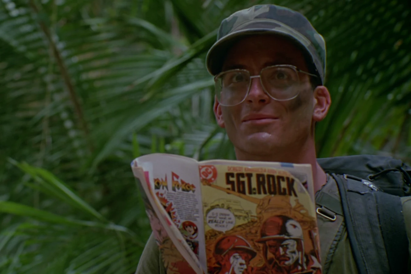 Rick Hawkins reading a Sgt. Rock comic in the jungle in Predator