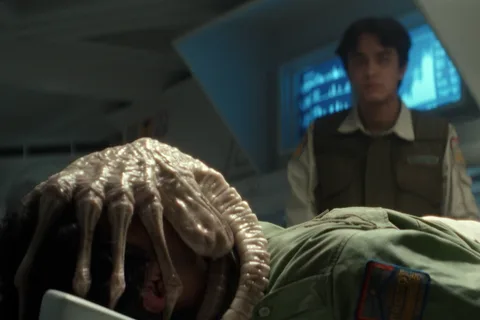 Facehugger attached to a human host in Alien: Earth