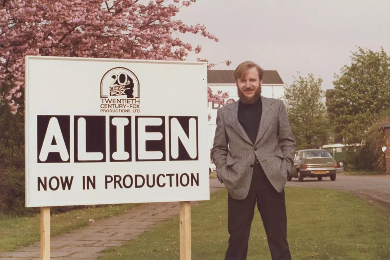 Dan O'Bannon beside an Alien now in production sign at Twentieth Century-Fox