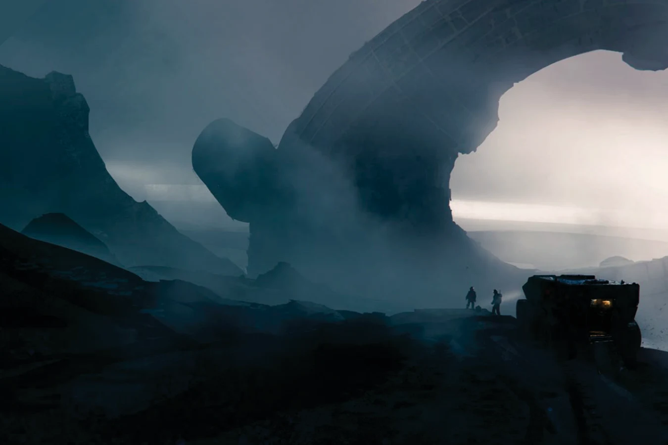 Two explorers and a rover before a buried Engineer Juggernaut on a foggy world
