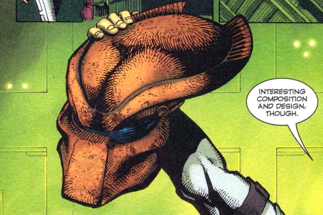 A hand holding the captive hunter's mask in the camp lab