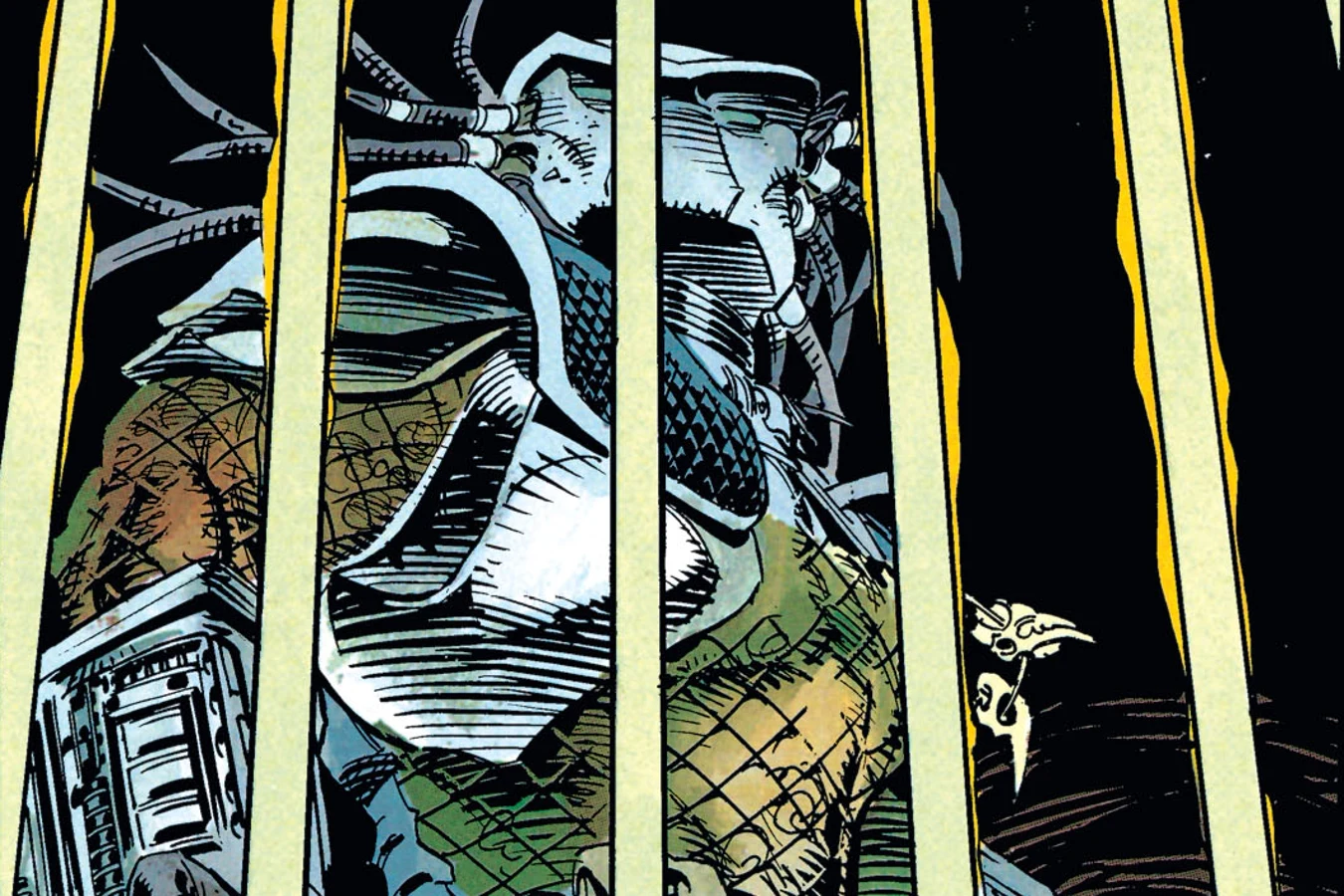 The Predator trapped behind the titanium steel bars of a cage in the Batcave in Batman vs. Predator