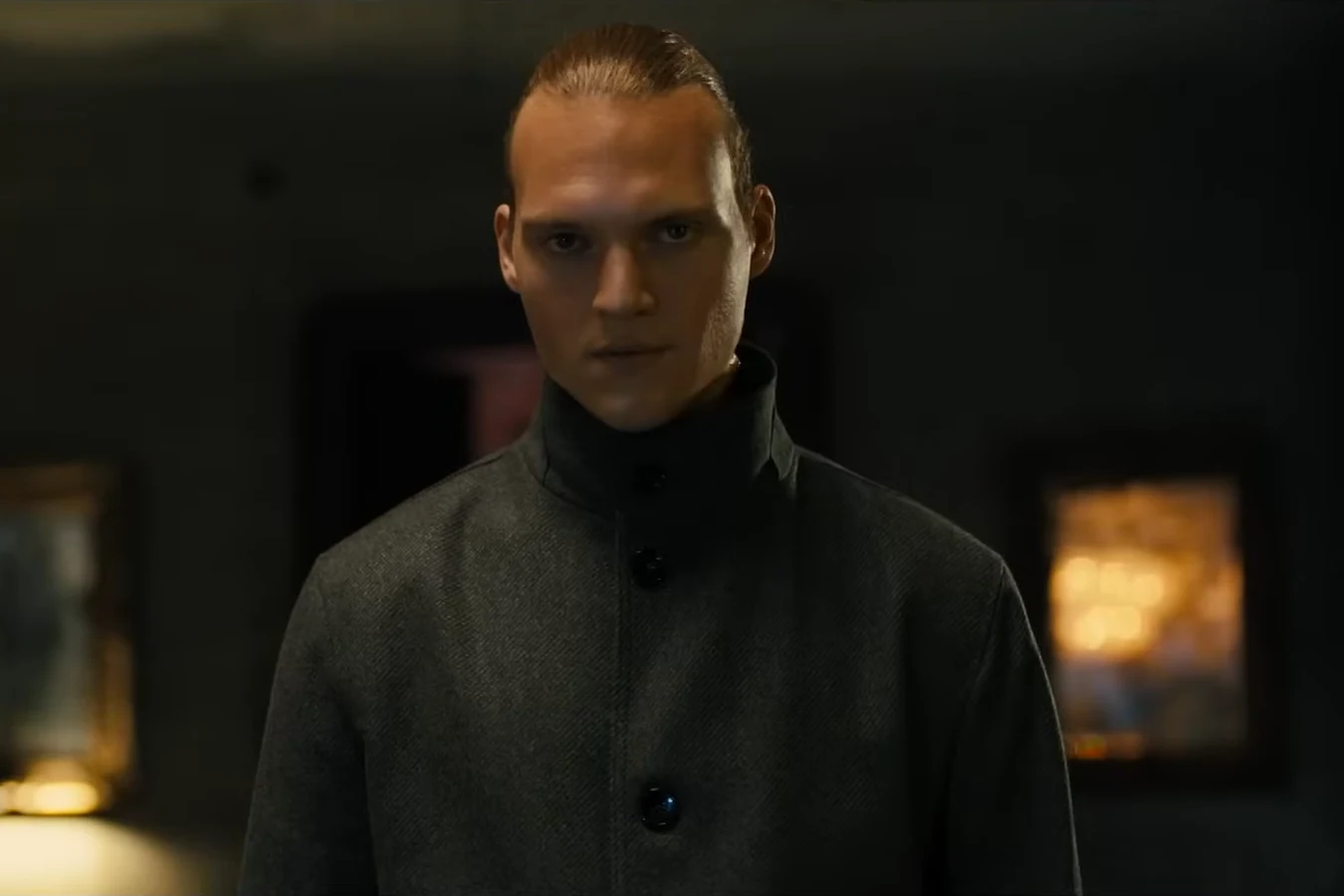 Wallace's tall blond Nexus-9 replicant in a high-collared dark grey coat facing the camera in 2036: Nexus Dawn