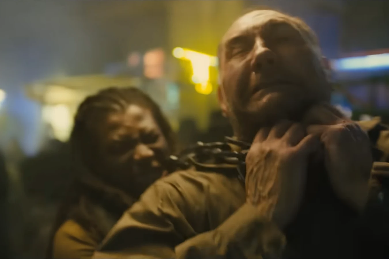 A thug grabbing Sapper Morton around the neck during the market fight in 2048: Nowhere to Run