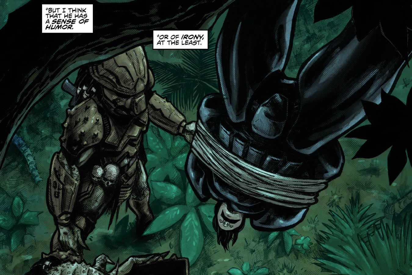 A Predator stands beside Raphael Herrera as he hangs bound and upside down from a tree on Tehua in Predator: Hunters III