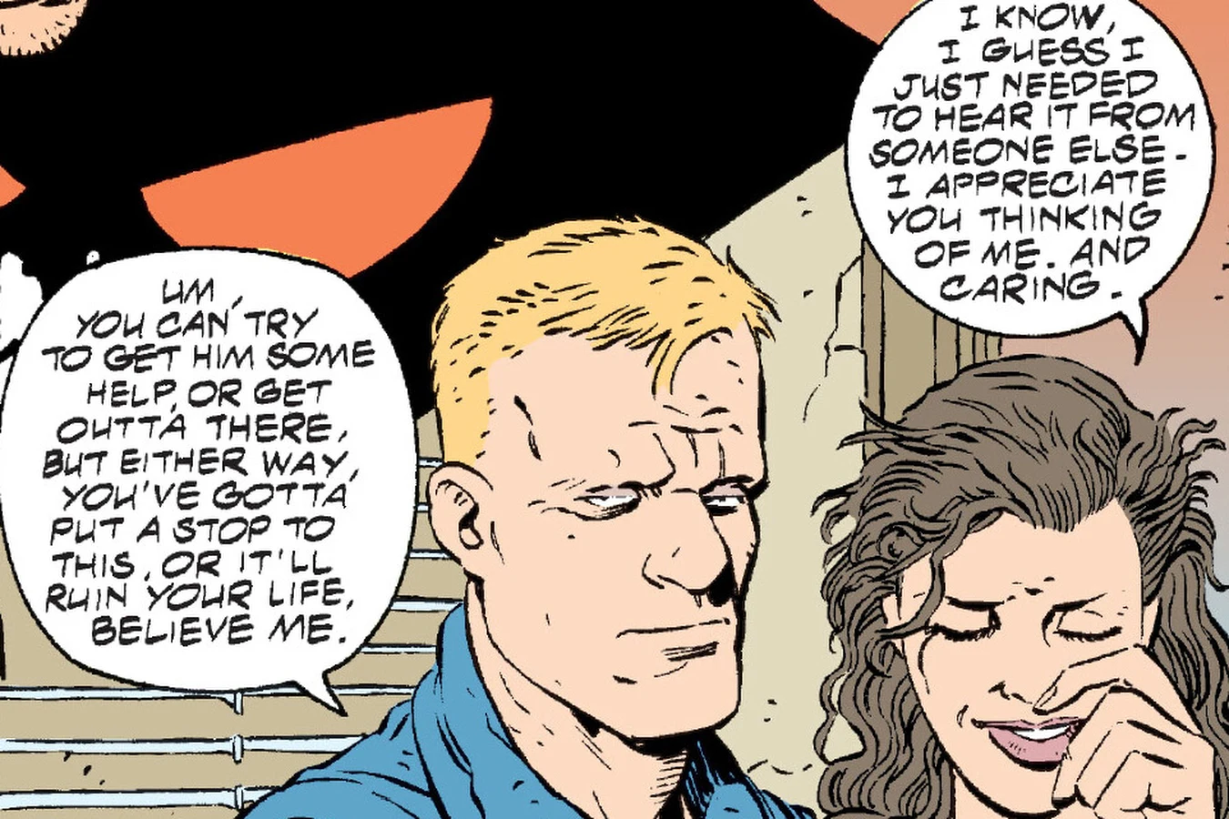 Buddy Wilcox in a blue shirt sits beside a crying Peggy Dennison and urges her to get help, in Predator: Kindred