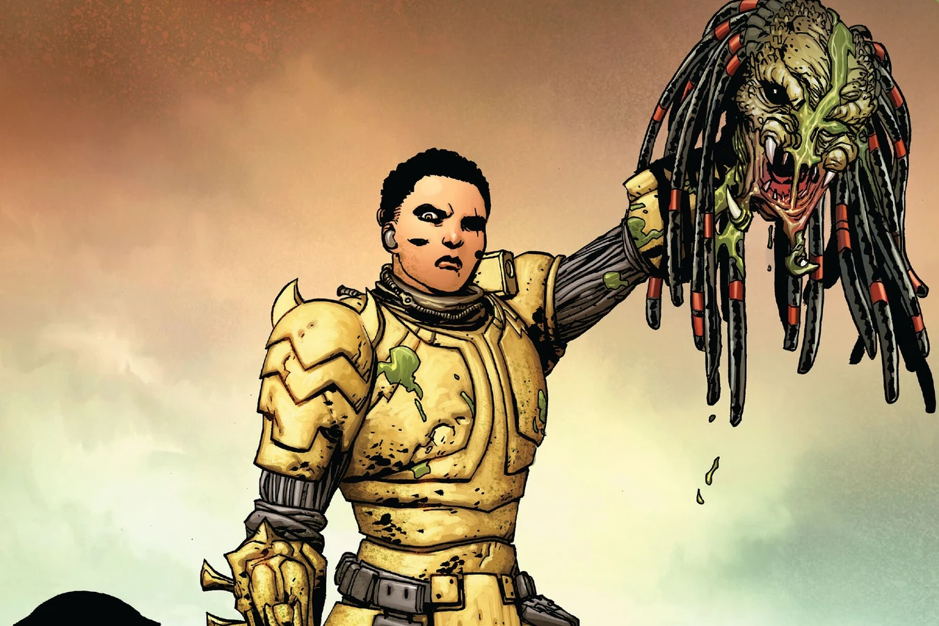 Theta Berwick in gold armor holds up a severed Predator head on the Predator #2 cover by Giuseppe Camuncoli