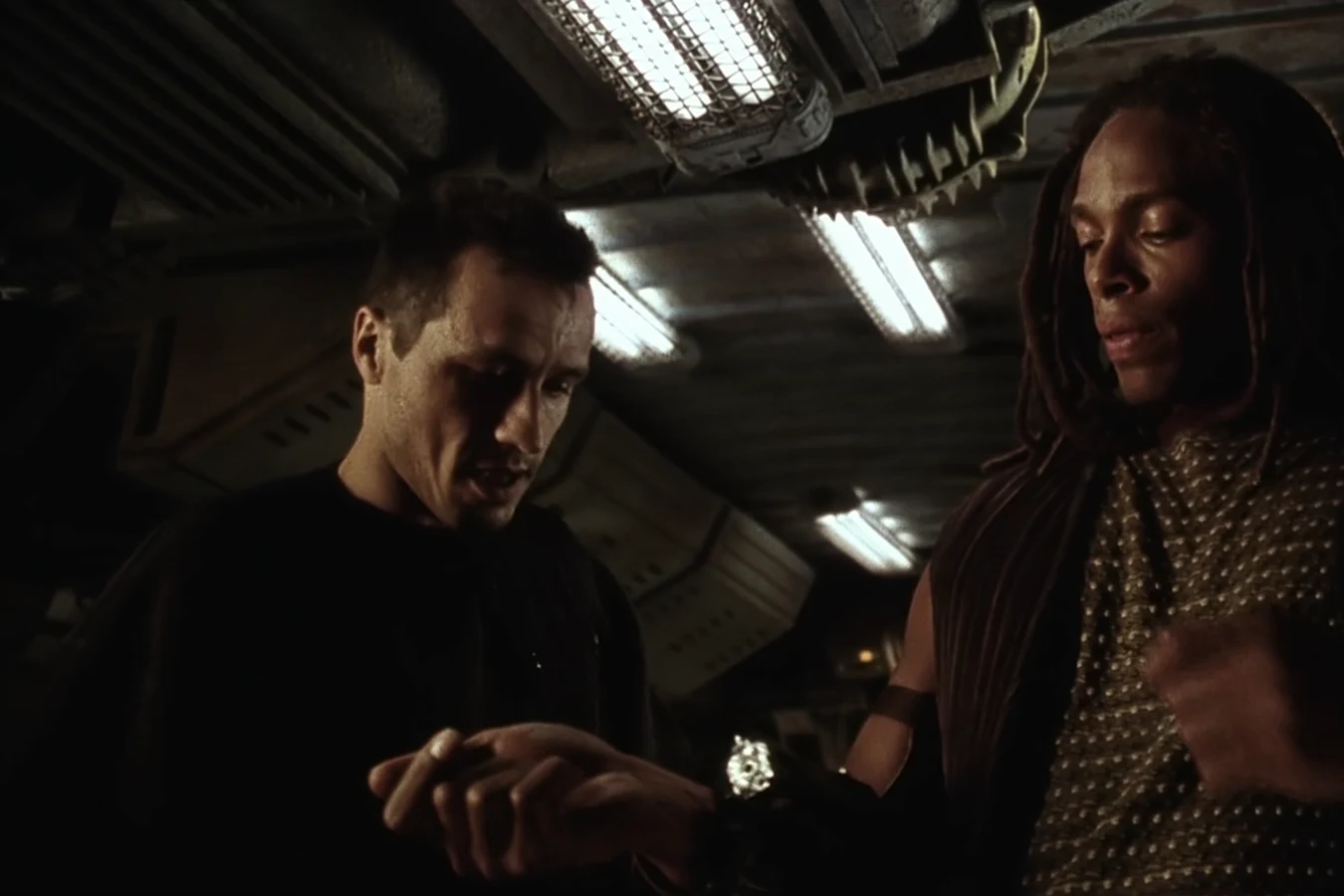 Elgyn helping Christie with the gun rigs on his forearms aboard the Betty