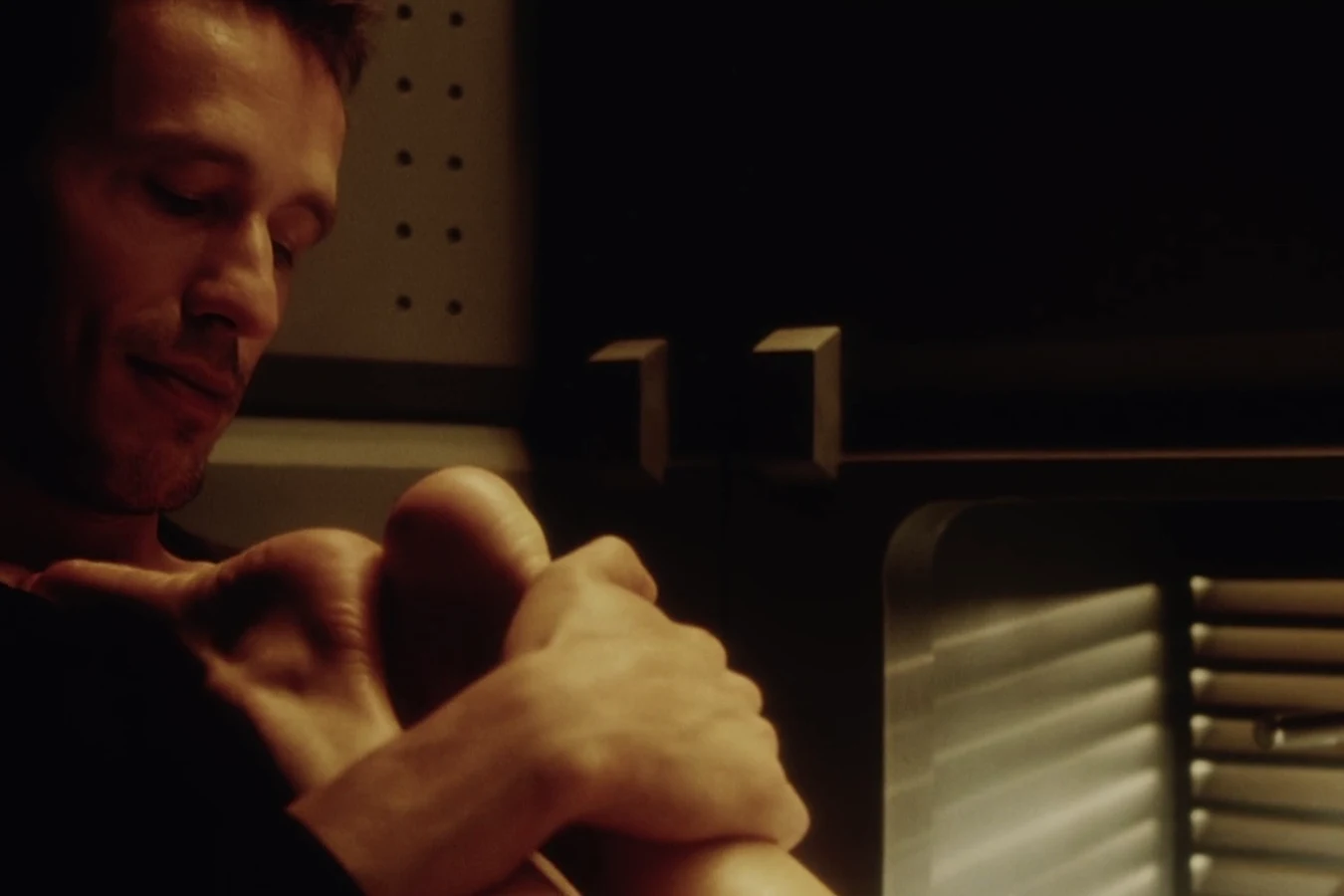 Elgyn smiling as he massages Hillard's feet in their quarters on the Auriga