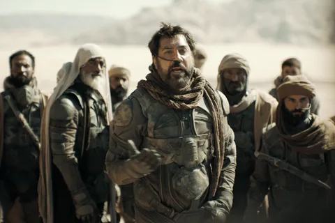 Fremen warriors in stillsuits standing in the desert of Arrakis