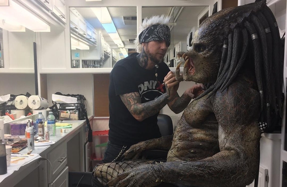 A Behind The Scenes photo of the Fugitive Predator costume being put on