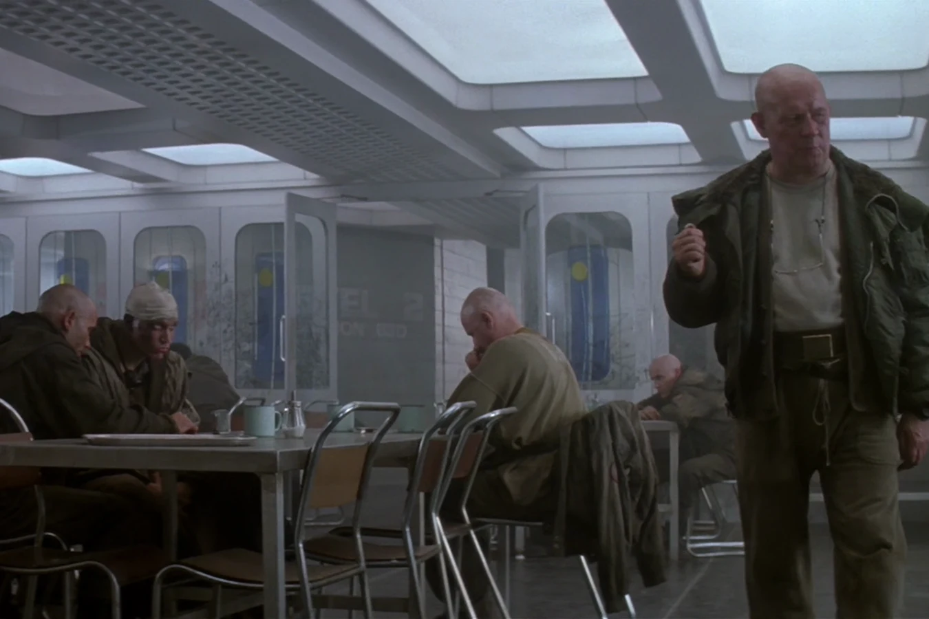 Shaved-head inmates eating in the Fiorina 161 mess hall