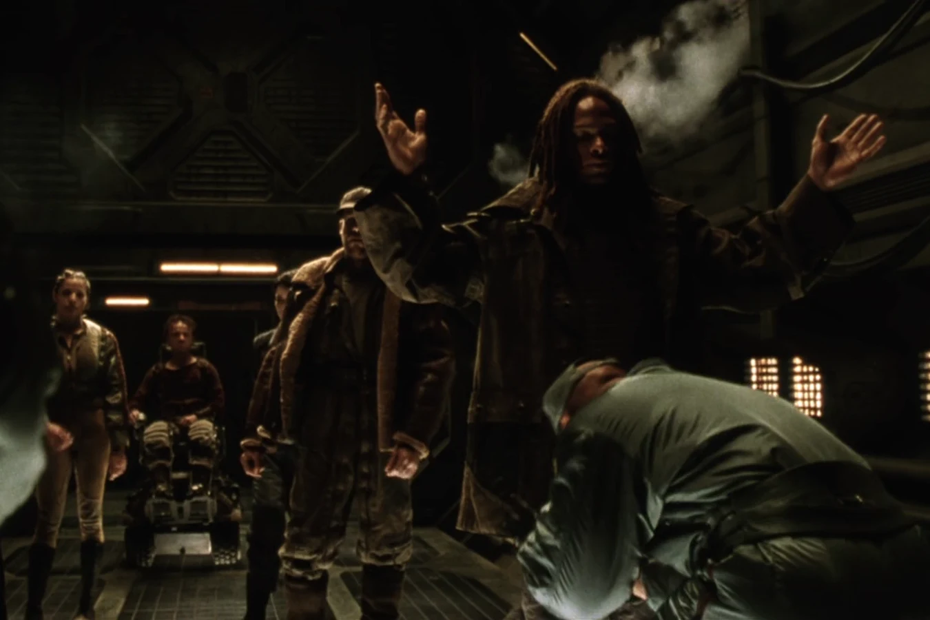 Christie raising his arms for the weapons scan at the Auriga docking airlock