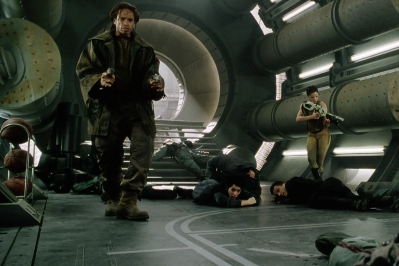 Christie walking past the fallen soldiers with his wrist guns out after the mess hall shootout