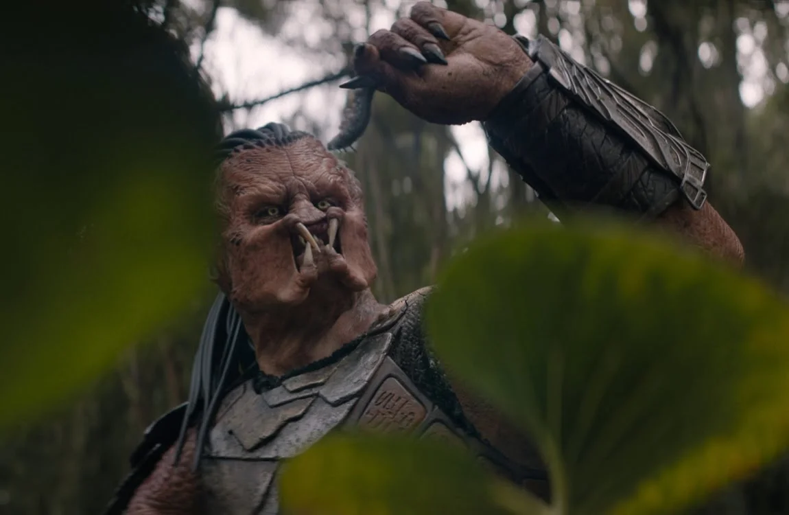 Dek holding an explosive worm on Genna