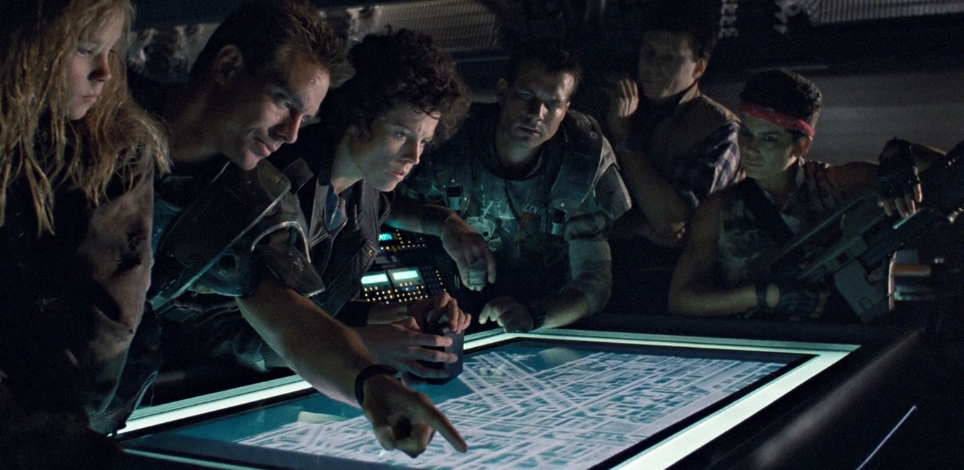 Colonial Marines and Ripley studying the Hadley's Hope map in Operations