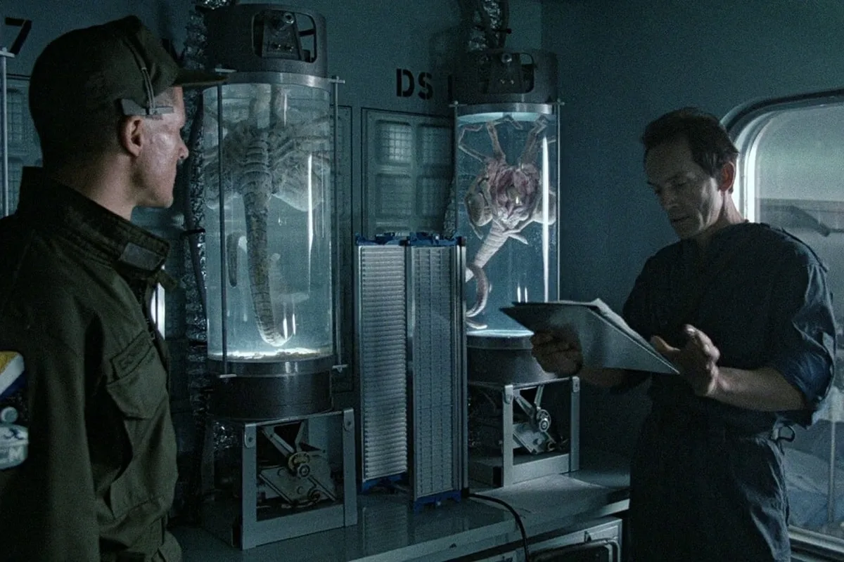 Bishop reading the John Marachuk facehugger removal report at Hadley's Hope