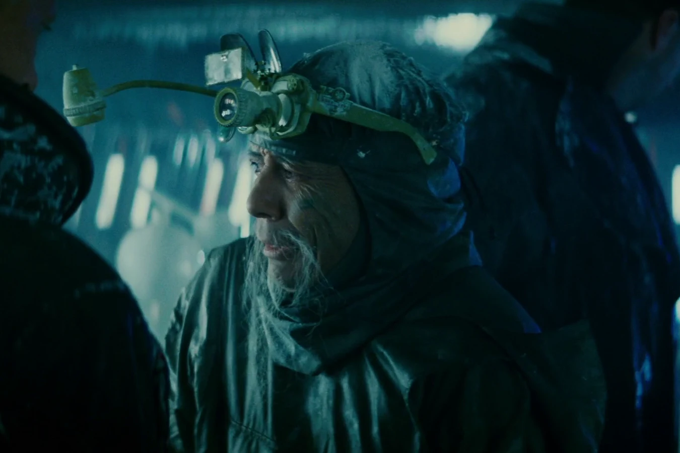 Chew in a hood and goggles with Leon standing behind him and Roy Batty in the foreground of the frozen eye lab in Blade Runner