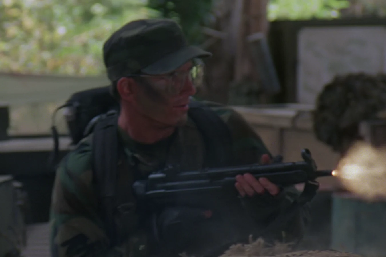 Rick Hawkins firing his submachine gun during the raid on the guerrilla camp in Predator