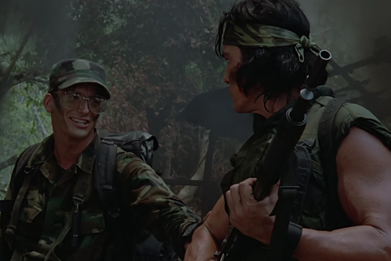 Rick Hawkins grinning as he talks with Billy on the march through the jungle in Predator