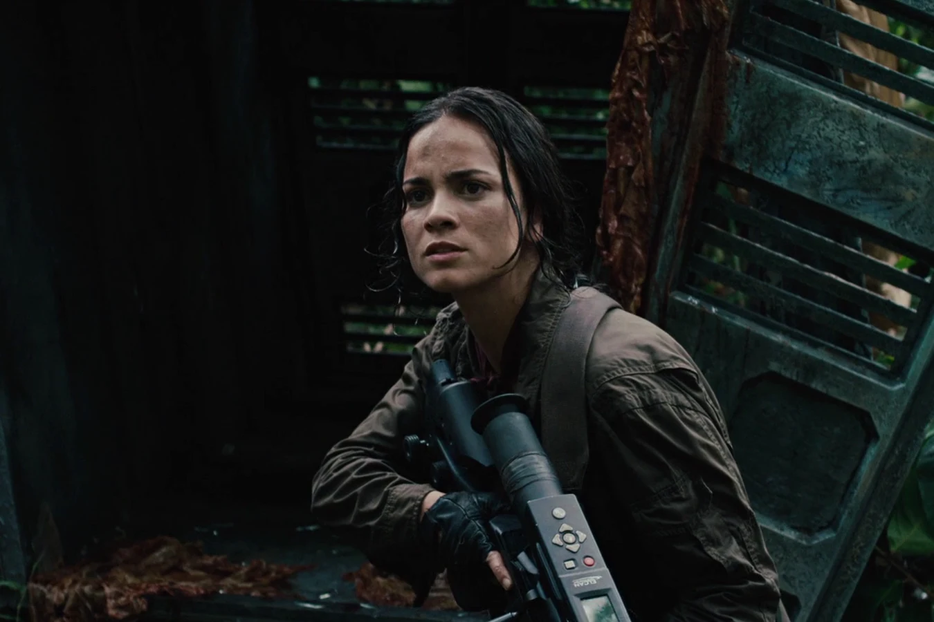Isabelle crouching with her sniper rifle beside metal wreckage in a dark forest