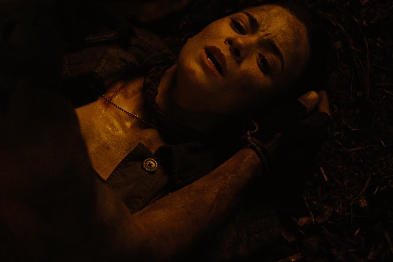Isabelle lying paralyzed on the ground at night with her head tilted back
