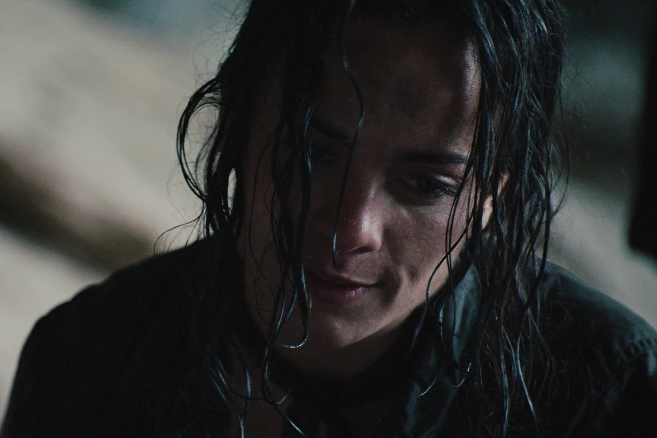 Isabelle looking down with her hair soaking wet after the jump into the river