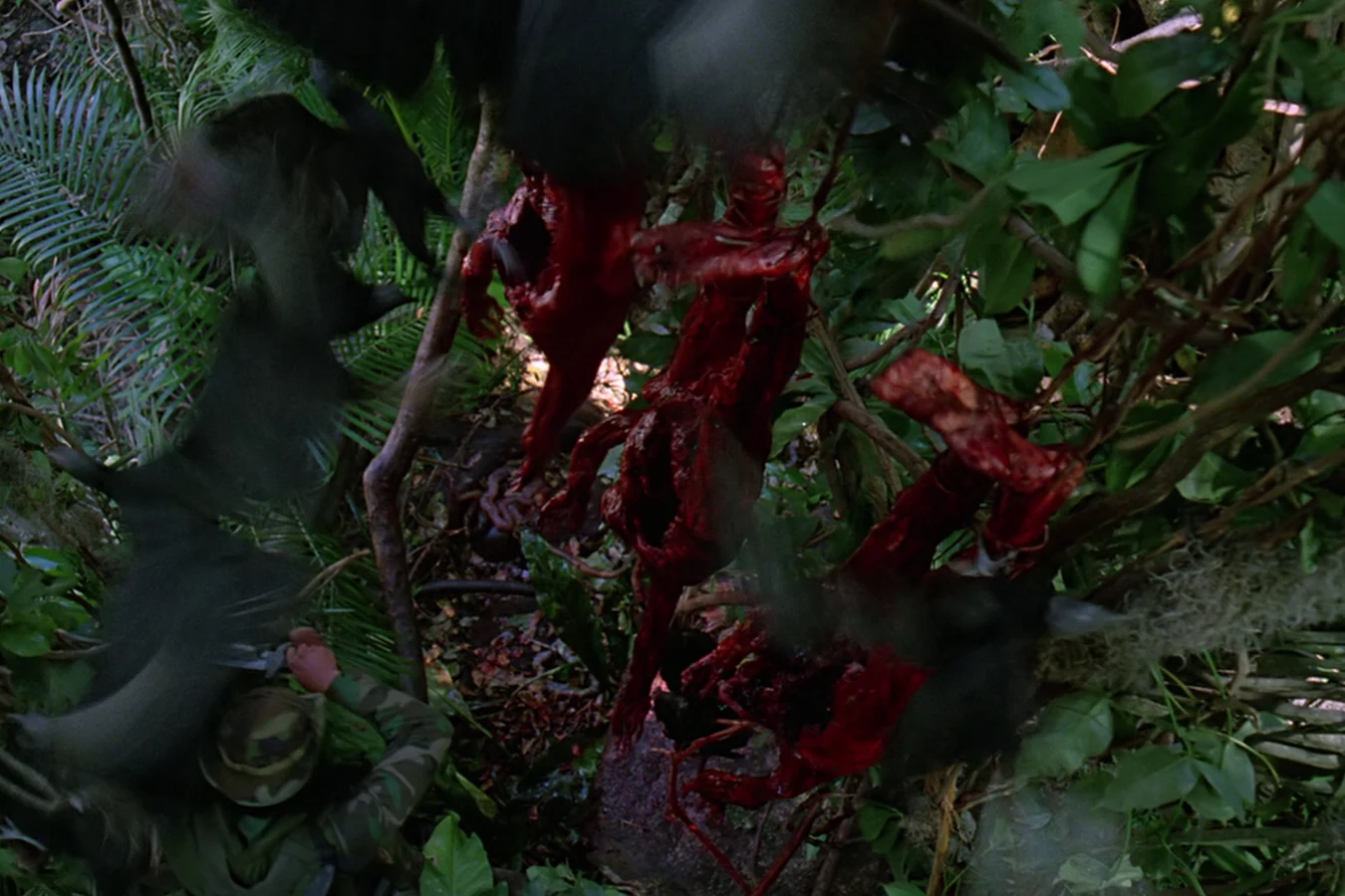 Dutch's squad looking up at the skinned bodies of Hopper's team in Predator